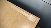 A light-colored wooden fork on a wooden table used for serving these healthy and delicious annatto seasoning recipes